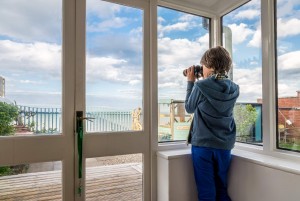 Boy looking out at Garden at Beach Cottage